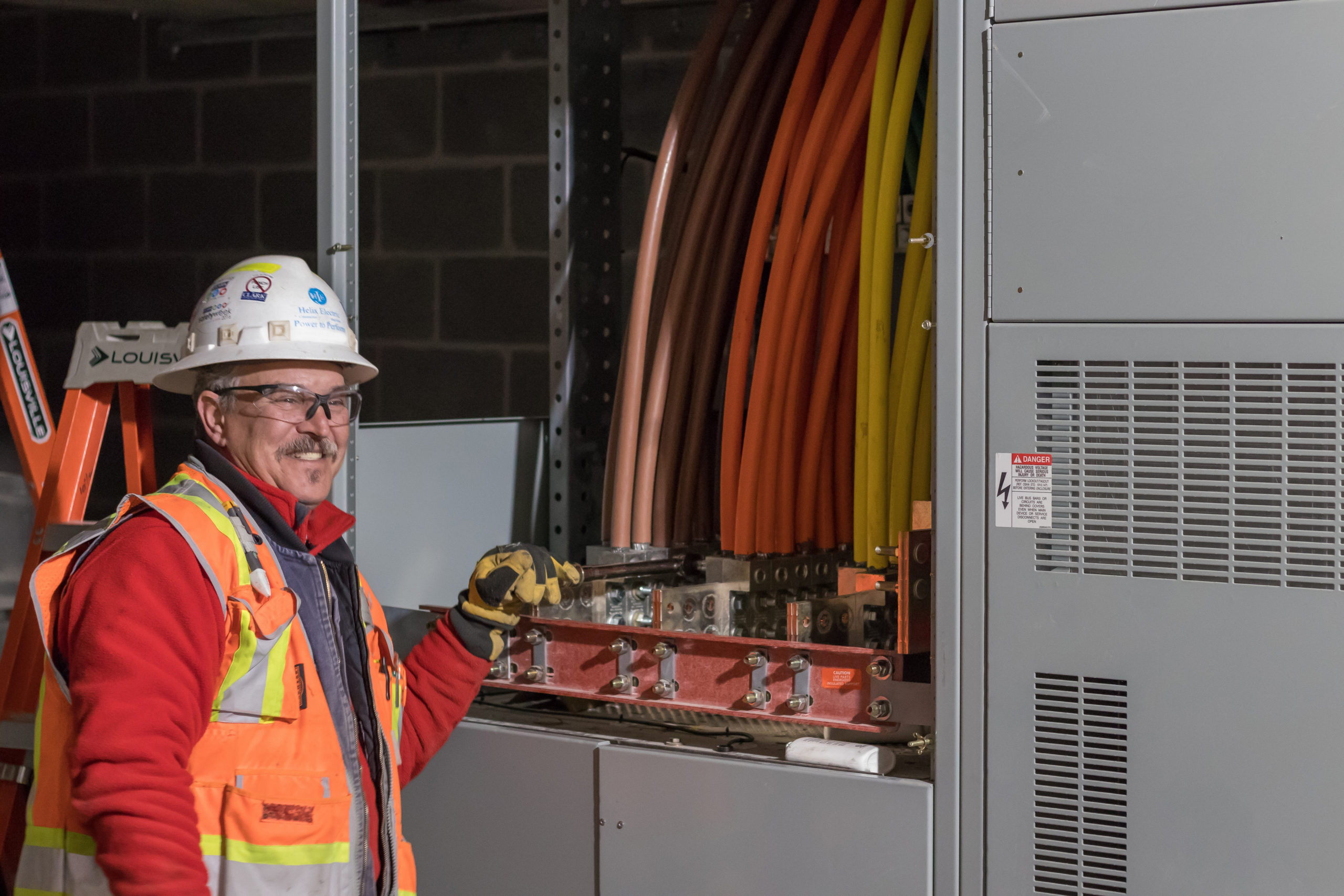 A Helix Electric employee smiles while working